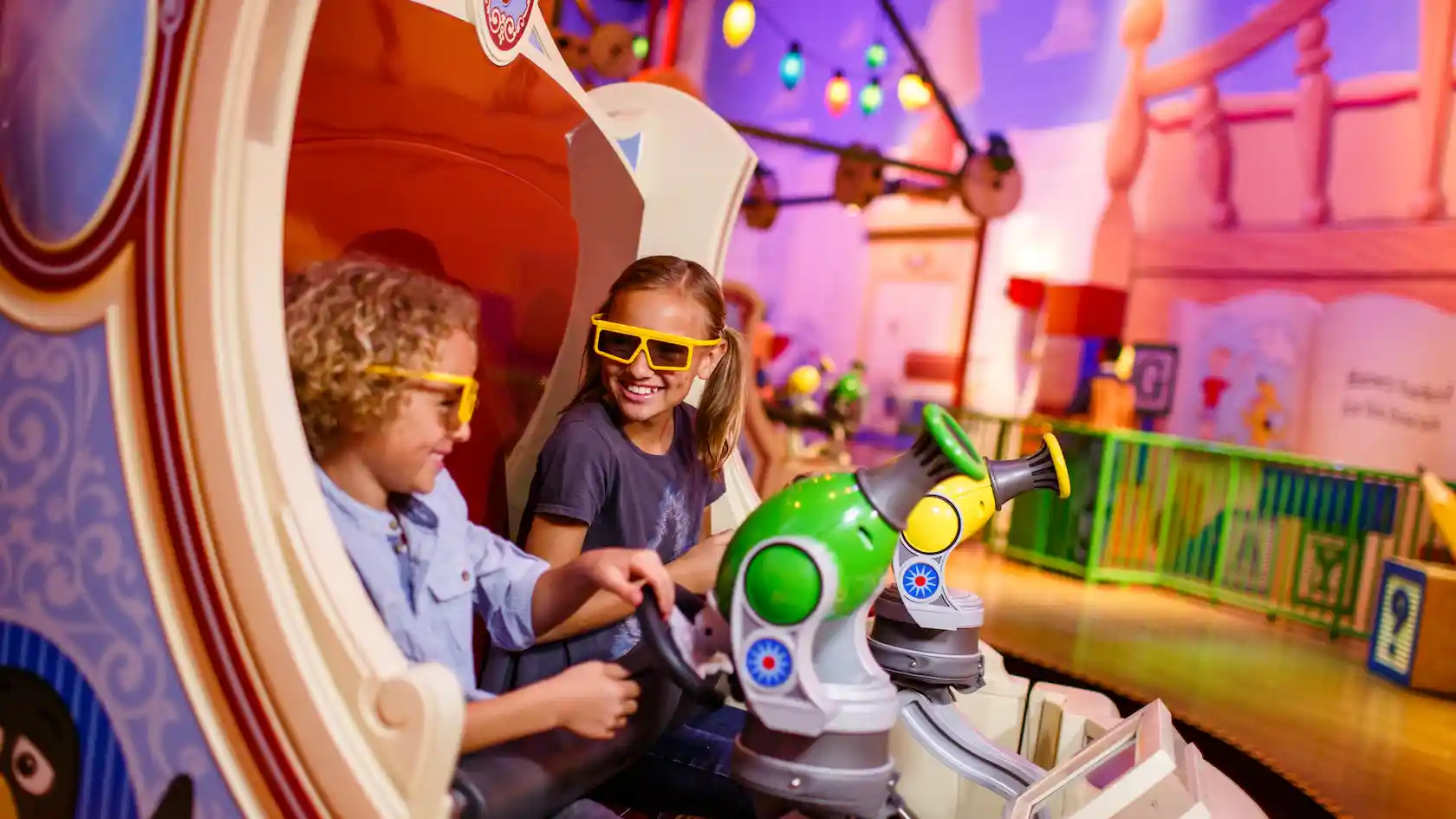 2 kids with 3D glasses on Toy Story Mania