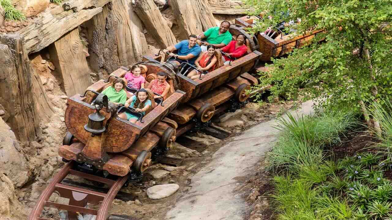 Kids and adults riding Mine Train rollercoaster