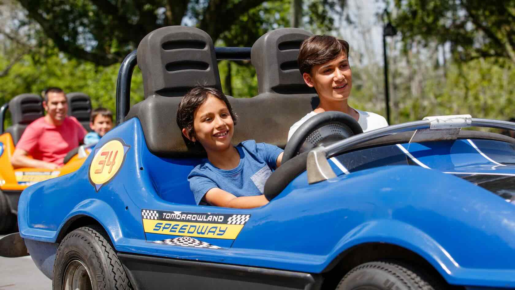 Two kids driving a race car