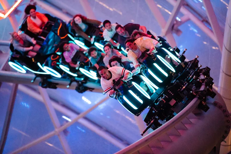 Park guests riding Tron at night